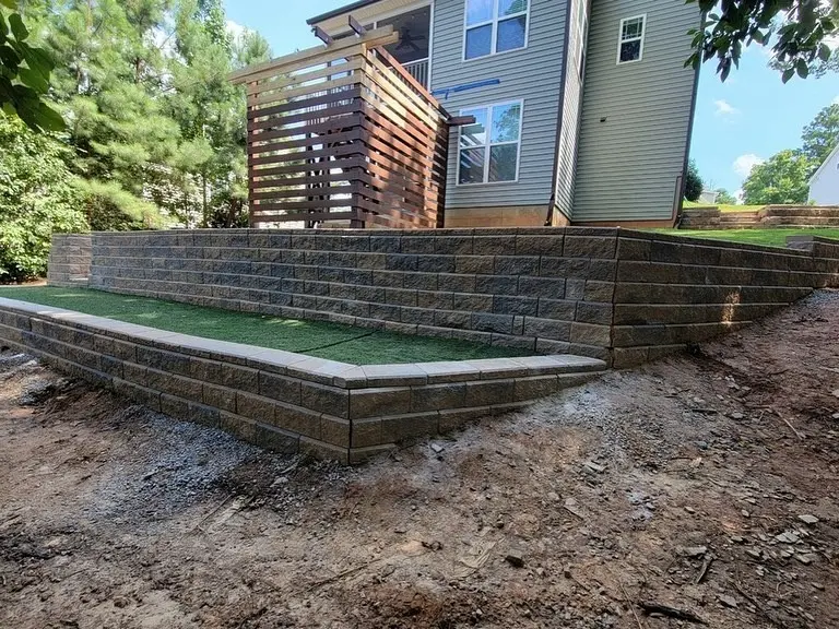 Tiered retaining wall with turf terrace and privacy screen