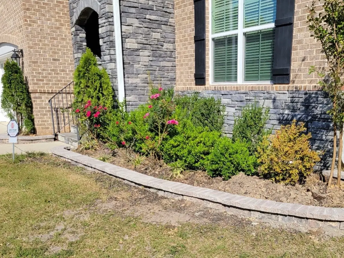 Paver edging and flowering garden bed