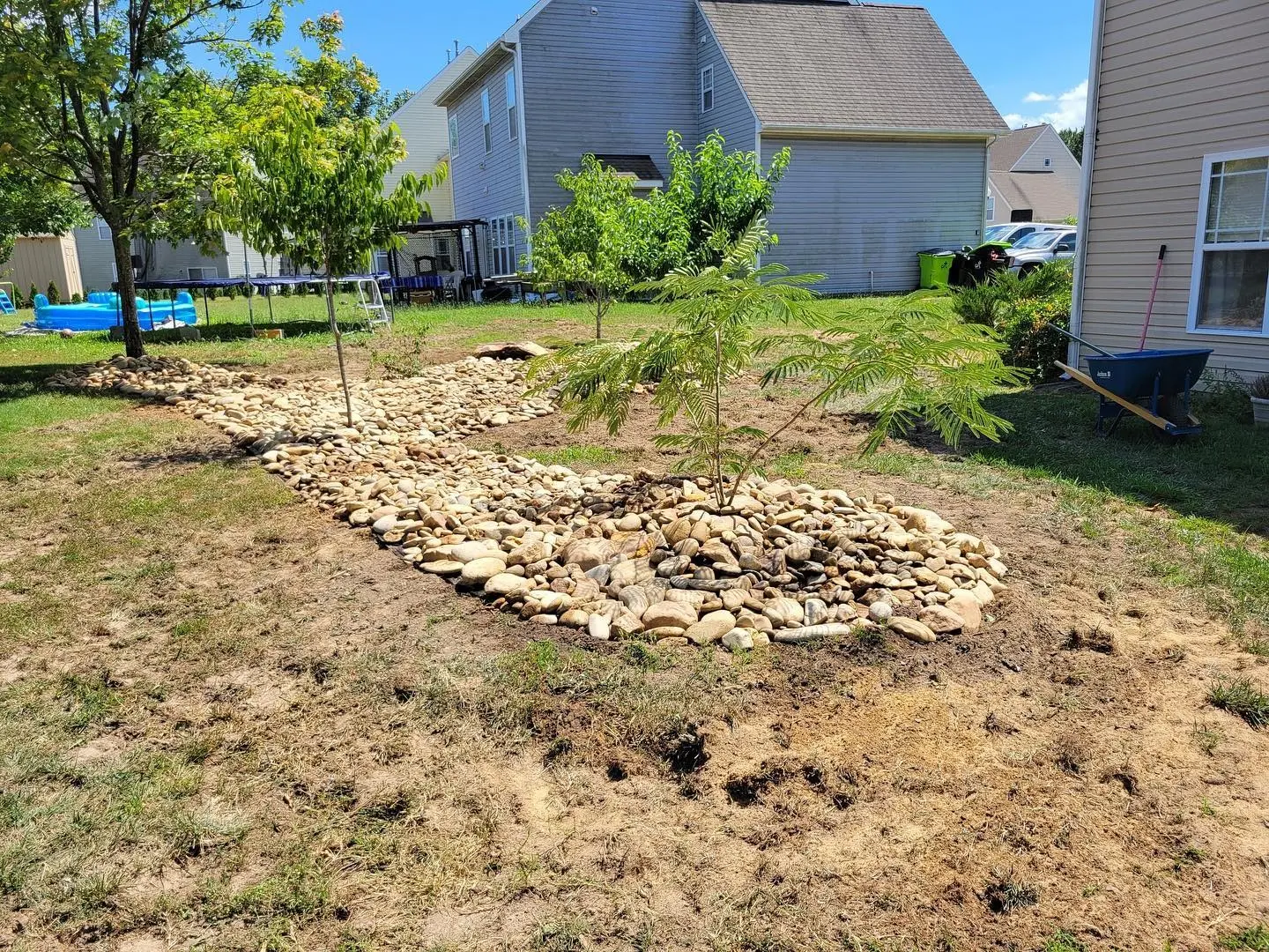 Dry creek bed with river rock and new plantings